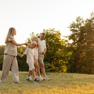 Happy family walking in nature during sunset, enjoying time and bonding outdoors