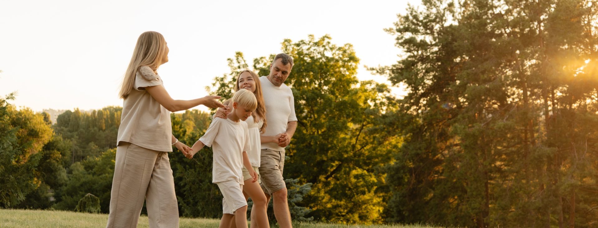 Happy family walking in nature during sunset, enjoying time and bonding outdoors